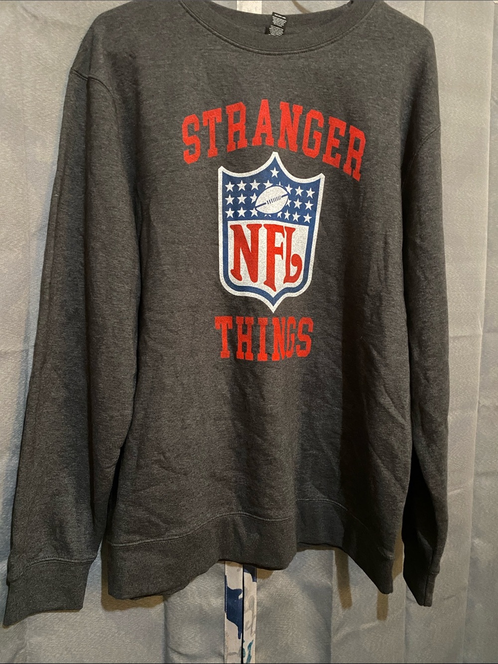 NFL Stranger Things Crewneck Sweatshirt - Dark Gray with Red & Blue Logo